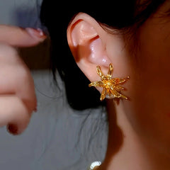 Model showcasing the dangle and style of the 14K Gold-Plated Luxury Flower Pearl Jacket Earrings