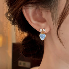 Angled view of the 14K Gold-Plated Zircon Bow Heart Earrings