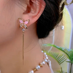 Model showcasing the dangle and style of the 14K Gold-Plated Zircon Butterfly Tassel Earrings