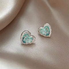 Angled view of the 14K Gold-Plated Elegant Lake Blue Heart Butterfly Stud Earrings