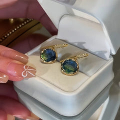 Close-up detail of the sparkling zircons and plating on the gold threader earrings