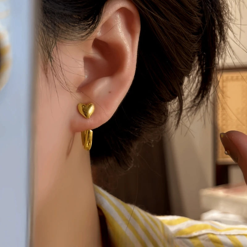 Close-up detail of the sparkling zircons and plating on the gold heart earrings