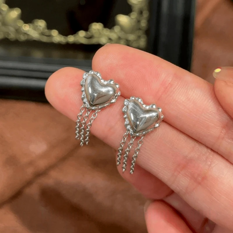 Angled view of the 14K Gold-Pated Heart-Design Tassel Earrings