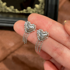 Angled view of the 14K Gold-Pated Heart-Design Tassel Earrings