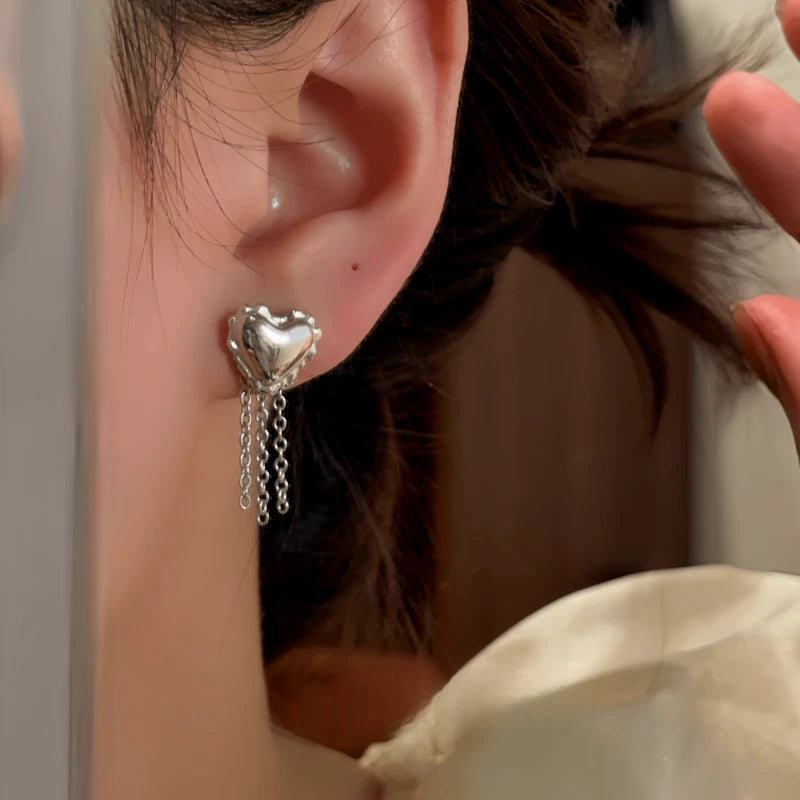 Close-up detail of the sparkling zircons and plating on the gold heart earrings