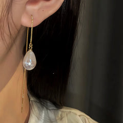 Model showcasing the dangle and style of the 14K Gold-Pated Water Drop Pearl Threader Earrings
