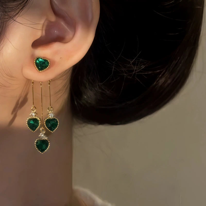 Close-up detail of the sparkling zircons and plating on the green heart earrings