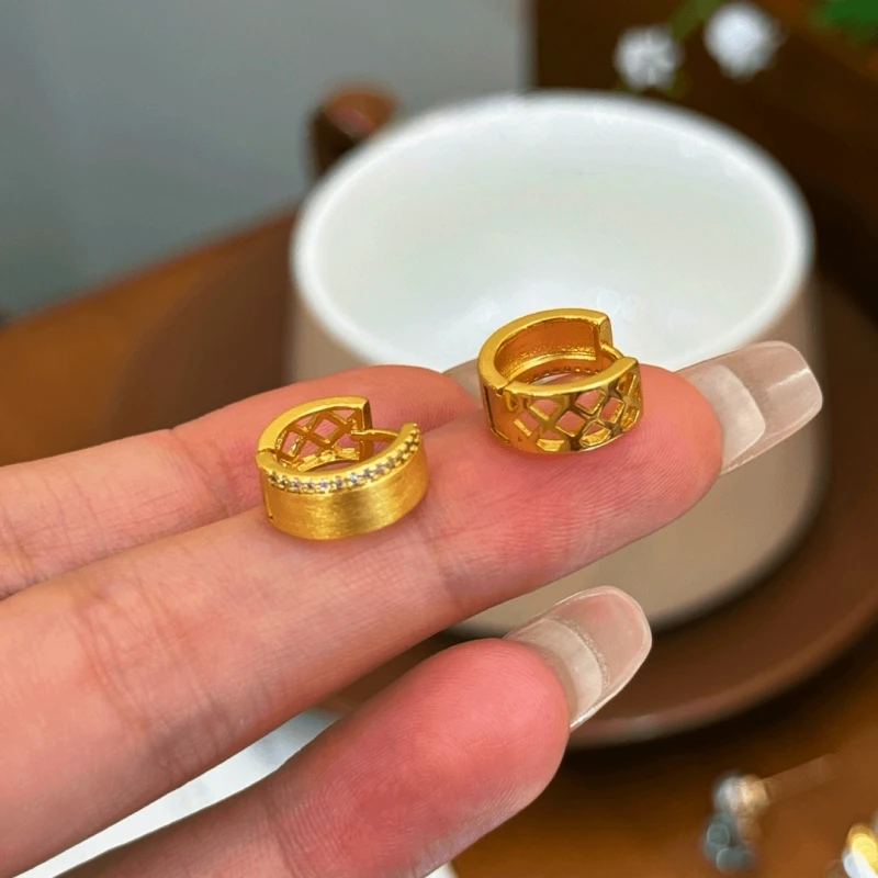 Close-up detail of the sparkling zircons and plating on the gold hoop earrings