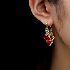 Model showcasing the dangle and style of the 14K Gold-Pated Zircon Rose Tassel Earrings