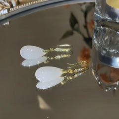 Close-up detail of the sparkling zircons and plating on the gold drop earrings