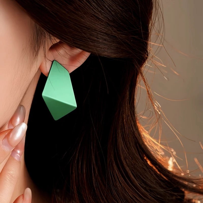 Close-up detail of the sparkling zircons and plating on the gold geometric earrings