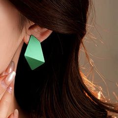 Close-up detail of the sparkling zircons and plating on the gold geometric earrings