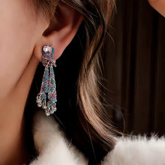 Close-up detail of the sparkling zircons and plating on the gold tassel earrings