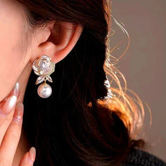 Close-up detail of the sparkling zircons and plating on the gold flower earrings