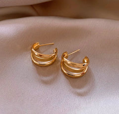 Close-up detail of the sparkling zircons and plating on the gold hoop earrings