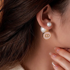 Close-up detail of the sparkling zircons and plating on the gold pearl earrings