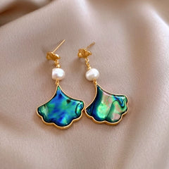 Model showcasing the dangle and style of the 14K Gold-Plated 2025 Elegant Pearl Leaf Earrings