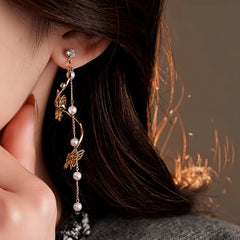 Model showcasing the dangle and style of the 14K Gold-Plated 2025 Elegant Zircon Butterfly Pearl Tassel Earrings