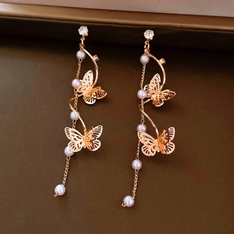 Angled view of the 14K Gold-Plated 2025 Elegant Zircon Butterfly Pearl Tassel Earrings