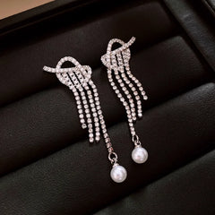 Model showcasing the dangle and style of the 14K Gold-Plated 2025 Elegant Zircon Diamond Knotted Pearl Tassel Earrings