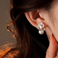 Close-up detail of the sparkling zircons and plating on the gold flower earrings