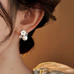 Close-up detail of the sparkling zircons and plating on the gold flower earrings
