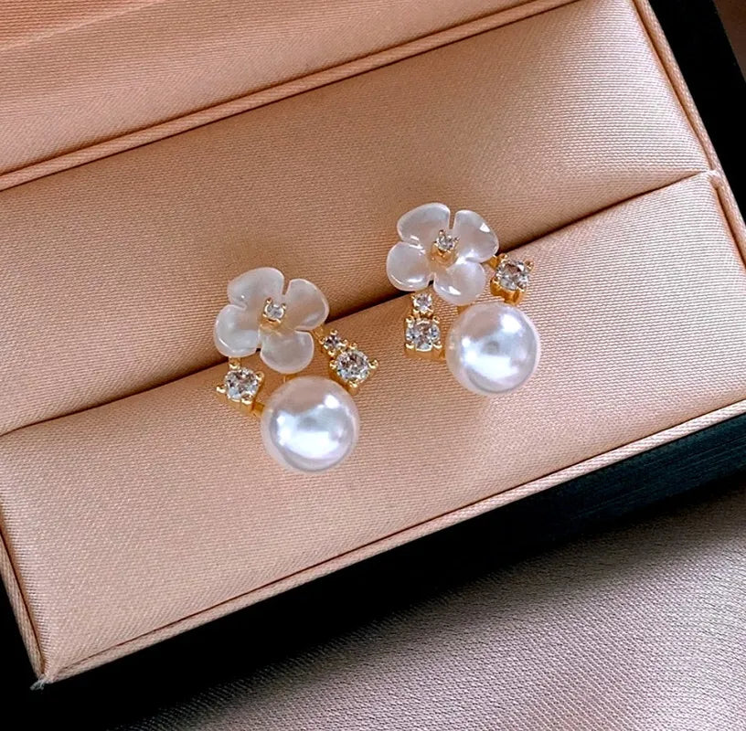 Model showcasing the dangle and style of the 14K Gold-Plated 2025 Elegant Zircon Flower Pearl Earrings