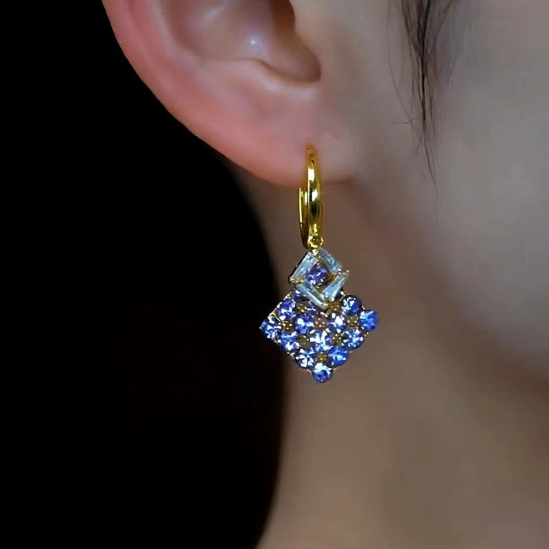 Close-up detail of the sparkling zircons and plating on the purple diamond earrings