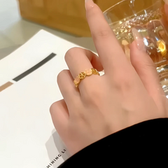 Close-up view of the gemstone and setting of the gold flower ring