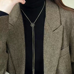 Close-up of the pendant and clasp on the gold rose necklace