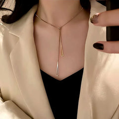 Close-up of the pendant and clasp on the gold triangle necklace