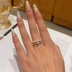 Close-up view of the gemstone and setting of the gold pearl ring