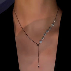 Close-up of the pendant and clasp on the silver clover necklace