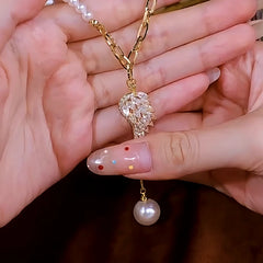 14K Gold-Plated Angel Wing Zircon Pearl Tassel Sweater Necklace worn to showcase its length and pendant detail