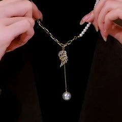 Close-up of the pendant and clasp on the angel wing necklace