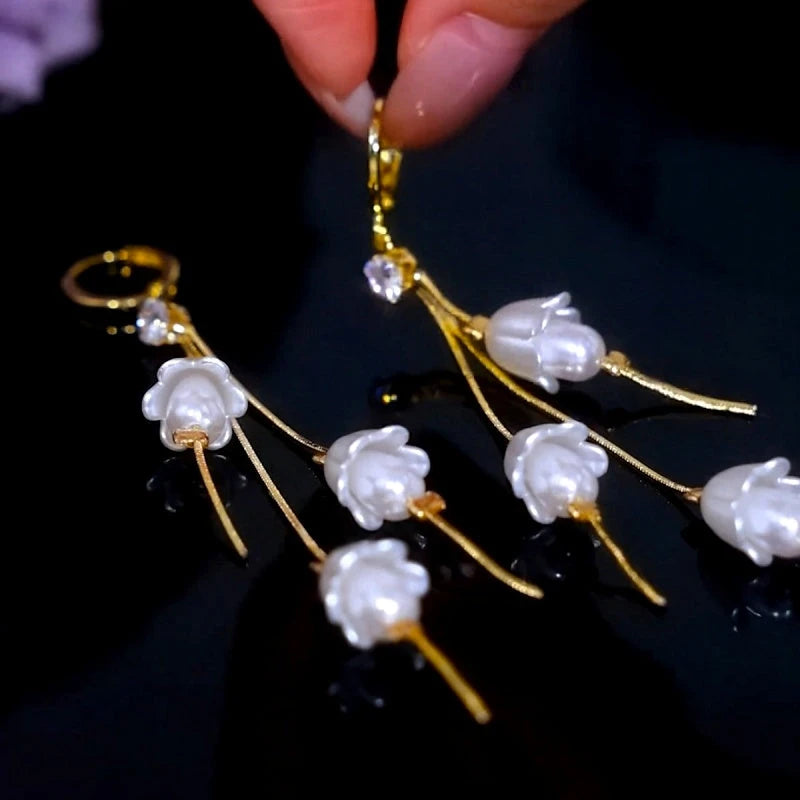Close-up detail of the sparkling zircons and plating on the gold flower earrings