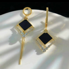 Angled view of the 14K Gold-Plated Asymmetrical Geometric Diamond Tassel Earrings
