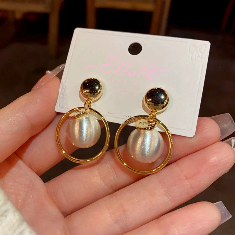 Angled view of the 14K Gold-Plated Ball Hoop Earrings