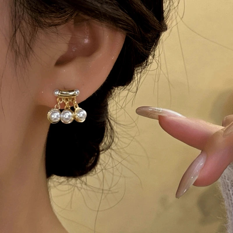 Close-up detail of the sparkling zircons and plating on the gold tassel earrings