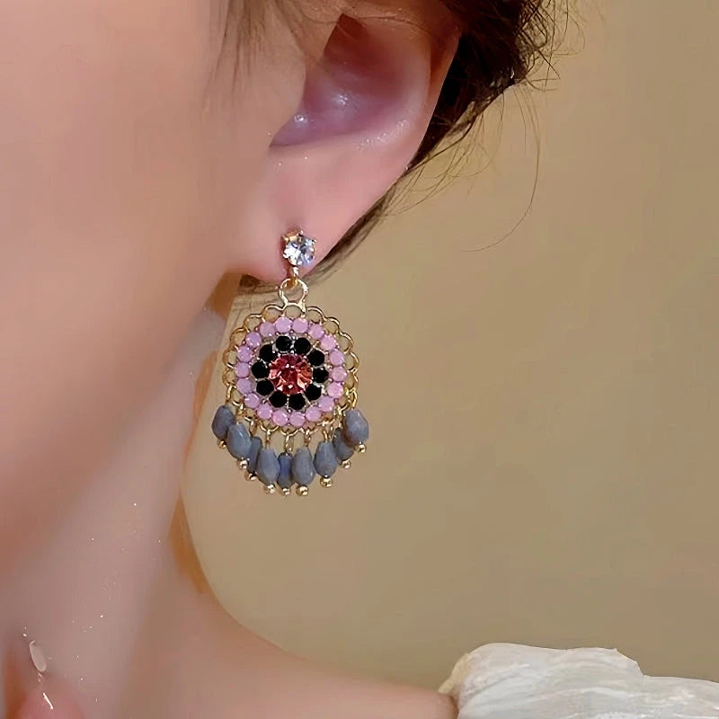 Model showcasing the dangle and style of the 14K Gold-Plated Beaded Tassel Earrings