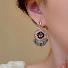 Close-up detail of the sparkling zircons and plating on the silver tassel earrings