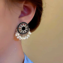 Close-up detail of the sparkling zircons and plating on the silver tassel earrings