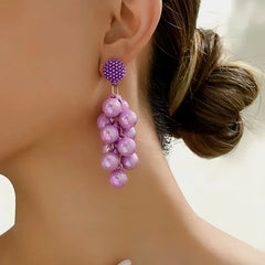 Close-up detail of the sparkling zircons and plating on the gold tassel earrings