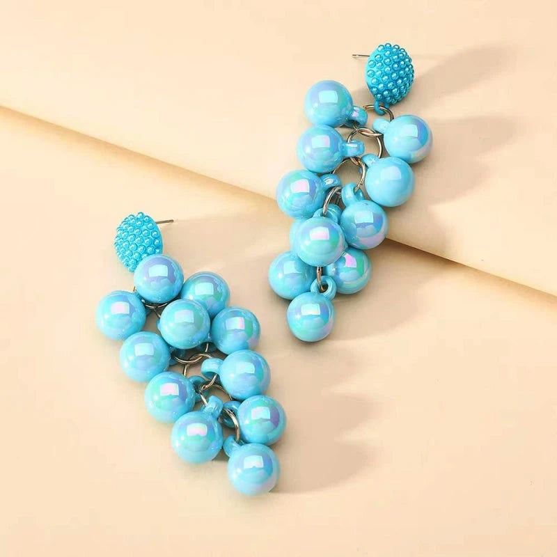 Detailed view of the sparkling accents on the gold tassel earrings