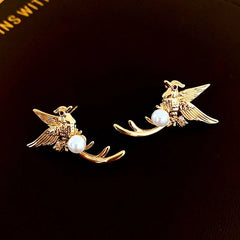 Angled view of the 14K Gold-Plated Bird Pearl Stud Earrings