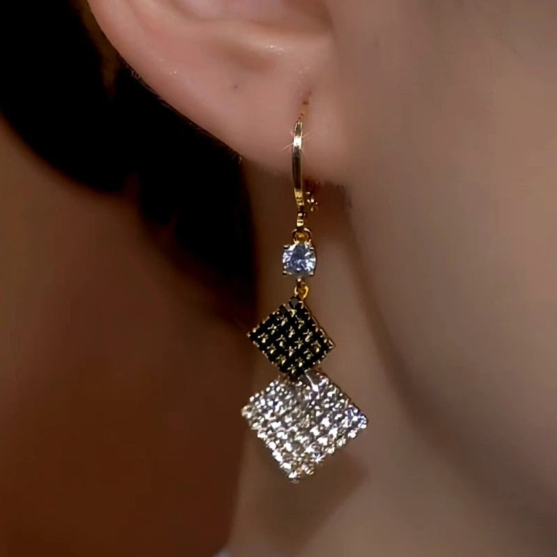 Close-up detail of the sparkling zircons and plating on the gold drop earrings