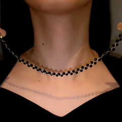 Close-up of the pendant and clasp on the gold bead necklace