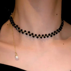 Detailed view of the 14K Gold-Plated Black Bead Necklaces chain and pendant