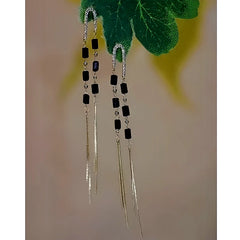 Angled view of the 14K Gold-Plated Black Crystal Long Tassel Earrings
