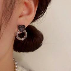 Close-up detail of the sparkling zircons and plating on the Heart Hoop Earrings